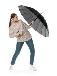 Photo of Young woman with black umbrella on white background