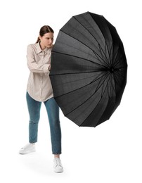 Photo of Young woman with black umbrella on white background