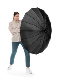 Photo of Young woman with black umbrella on white background