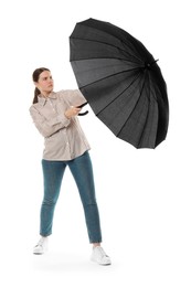 Photo of Young woman with black umbrella on white background