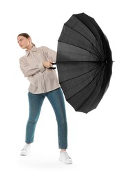 Photo of Young woman with black umbrella on white background