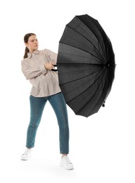 Photo of Young woman with black umbrella on white background