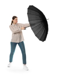 Photo of Young woman with black umbrella on white background