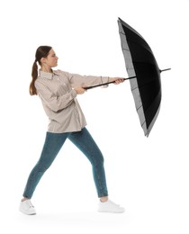 Young woman with black umbrella on white background