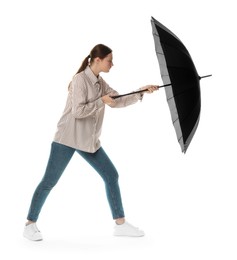 Photo of Young woman with black umbrella on white background