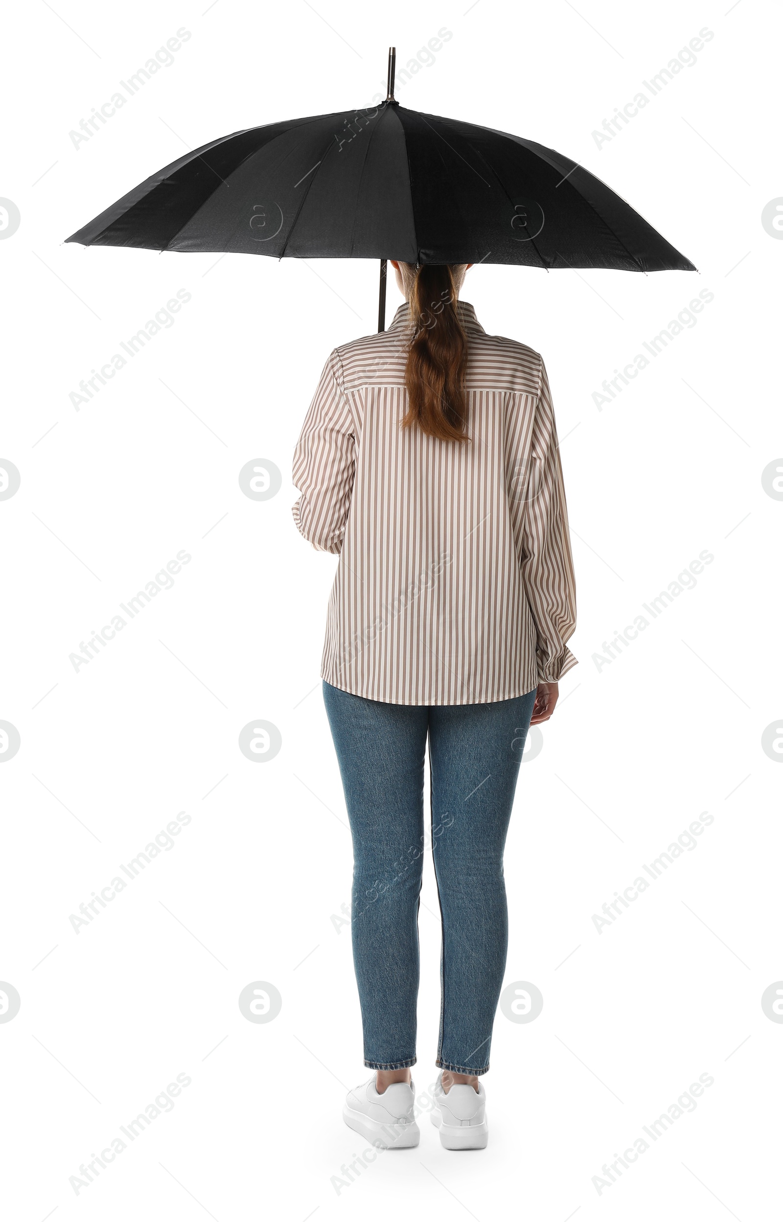 Photo of Young woman with black umbrella on white background, back view