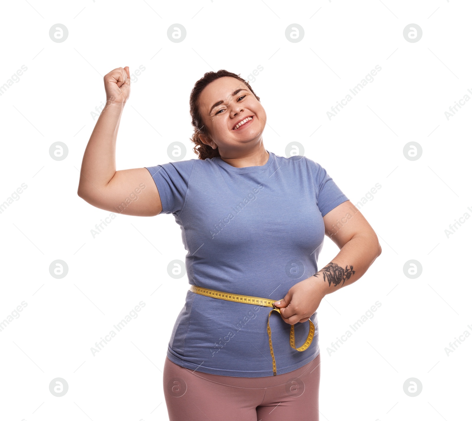 Photo of Weight loss. Happy plus size woman measuring waist with tape on white background