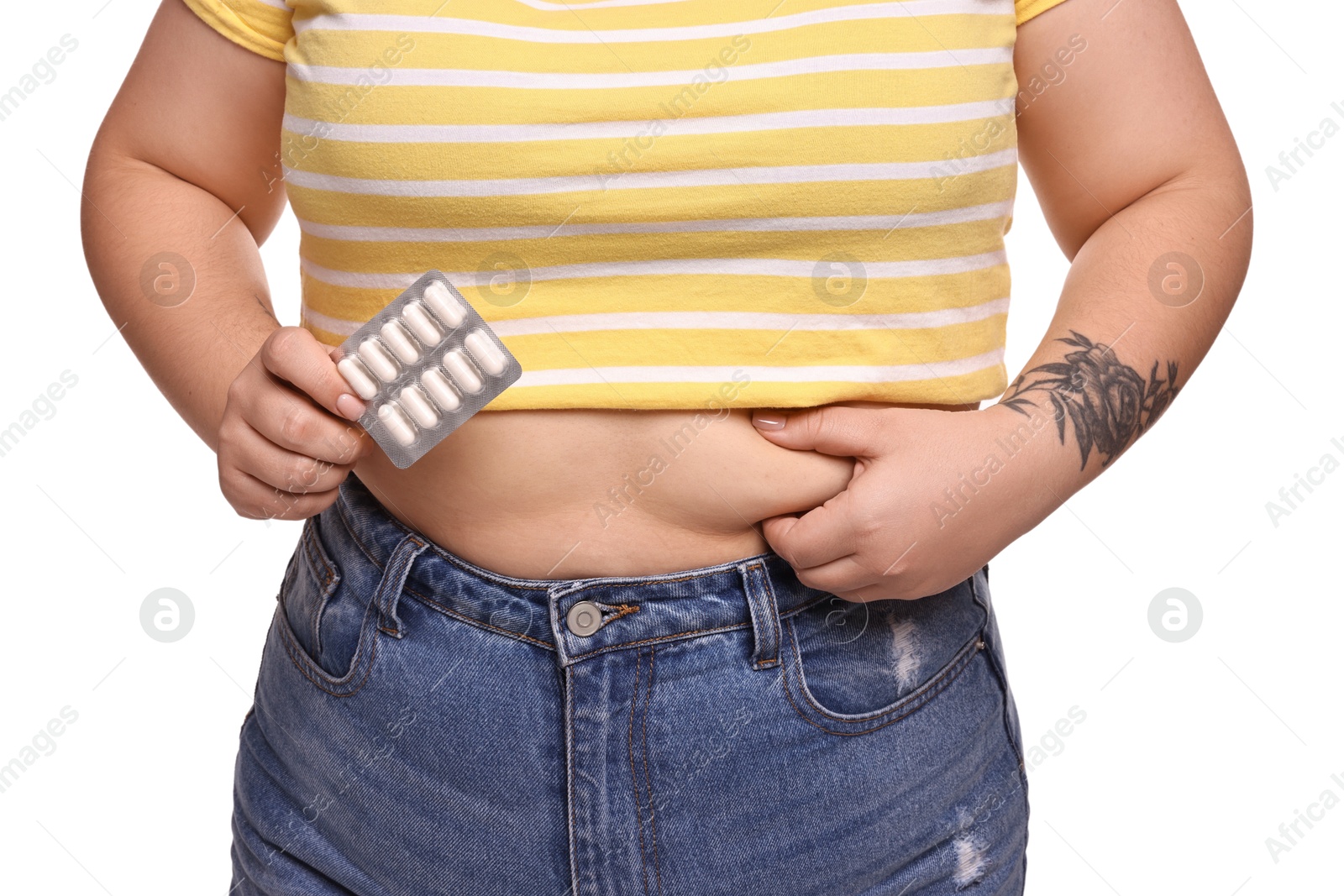 Photo of Plus size woman with blister of weight loss supplements on white background, closeup