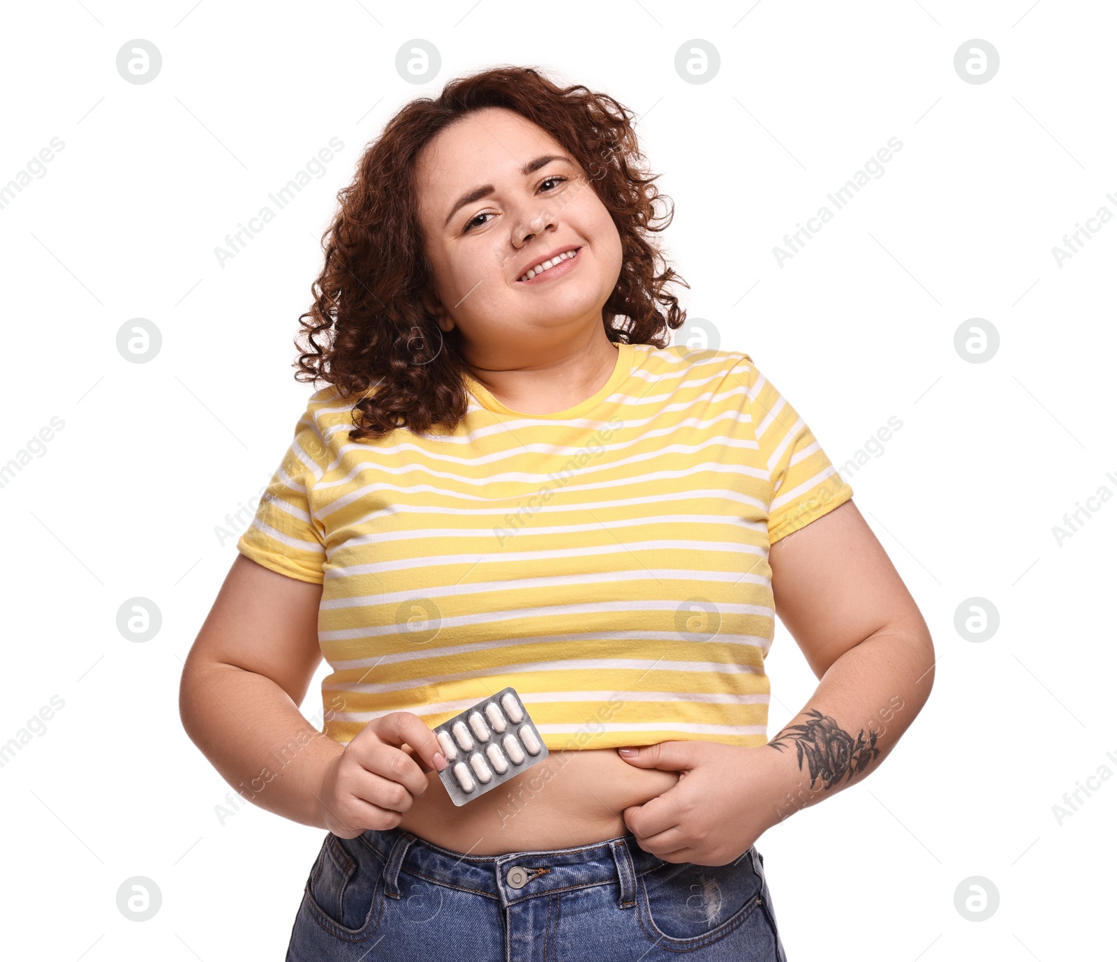 Photo of Happy plus size woman with blister of weight loss supplements on white background