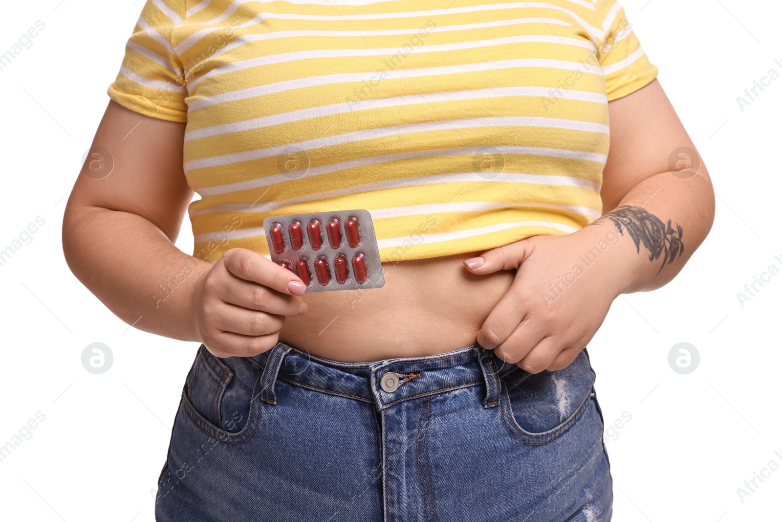 Photo of Plus size woman with blister of weight loss supplements on white background, closeup