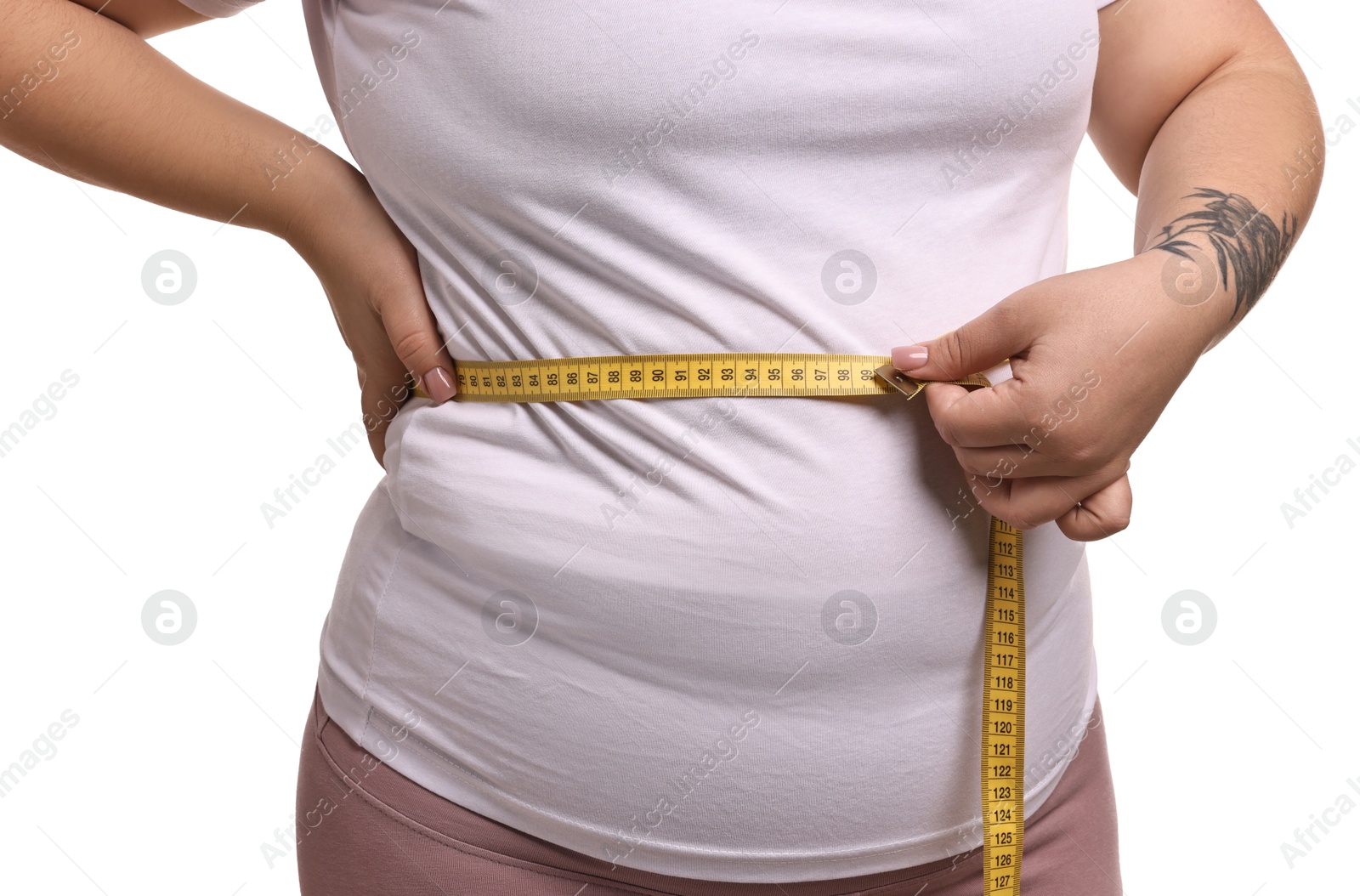 Photo of Weight loss. Plus size woman measuring waist with tape on white background, closeup