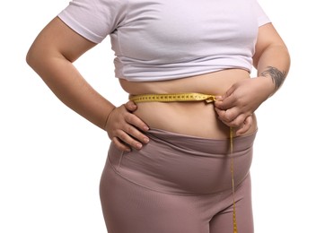 Photo of Weight loss. Plus size woman measuring waist with tape on white background, closeup