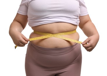 Photo of Weight loss. Plus size woman measuring waist with tape on white background, closeup