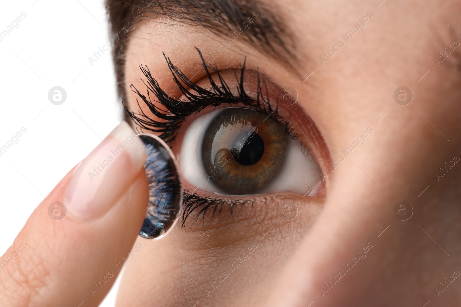 Photo of Woman putting in blue color contact lens on white background, closeup