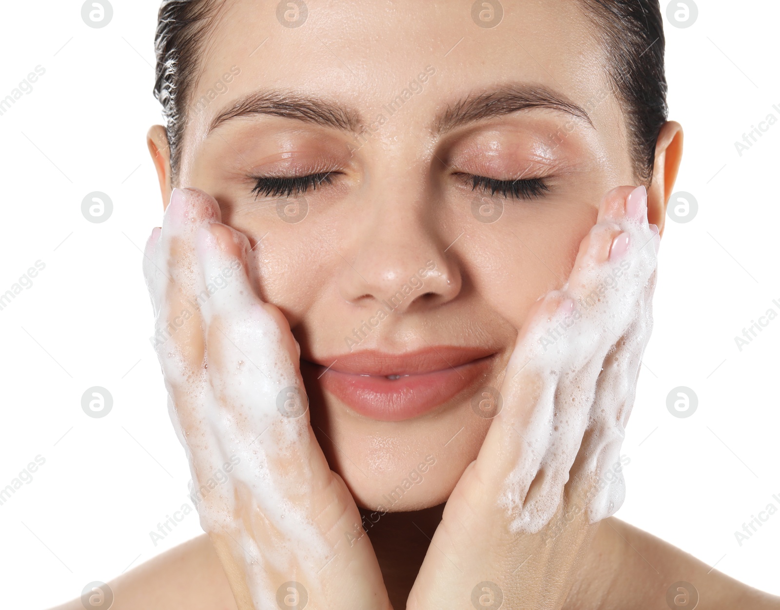 Photo of Beautiful woman washing her face with cleansing foam on white background, closeup