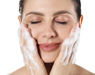 Photo of Beautiful woman washing her face with cleansing foam on white background, closeup