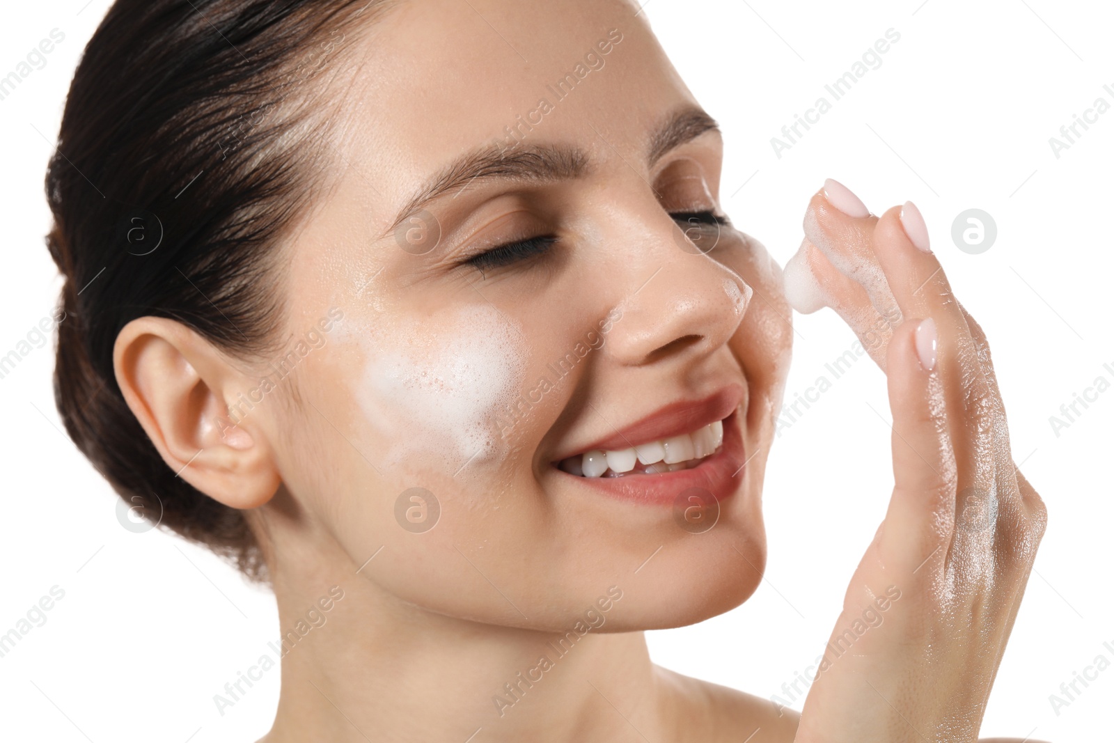 Photo of Smiling woman washing her face with cleansing foam on white background, closeup