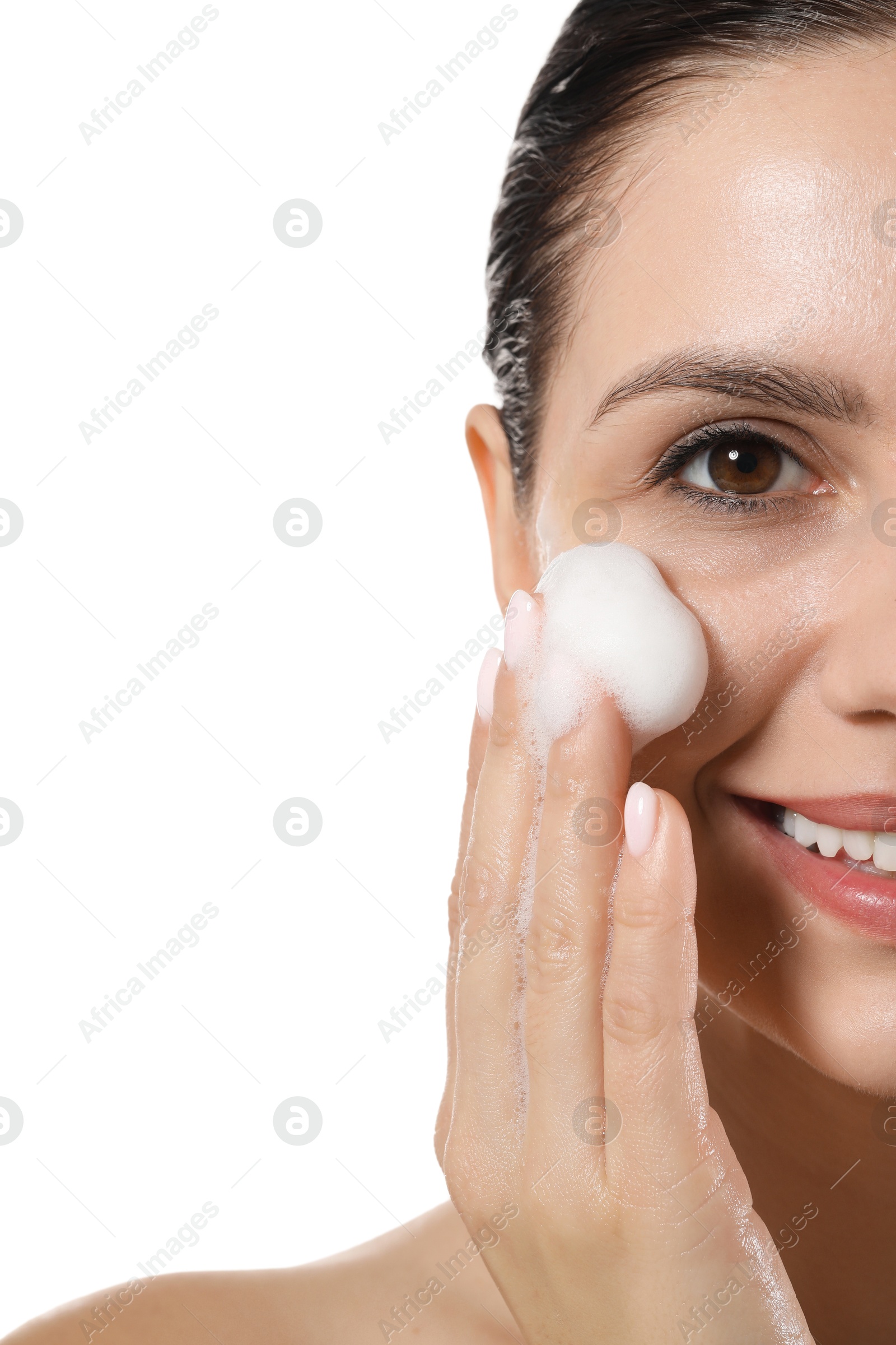 Photo of Smiling woman washing her face with cleansing foam on white background, closeup