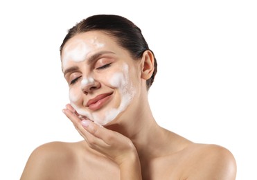 Beautiful woman washing her face with cleansing foam on white background