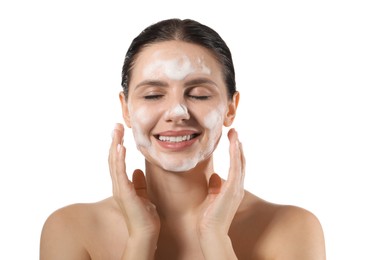 Photo of Smiling woman washing her face with cleansing foam on white background