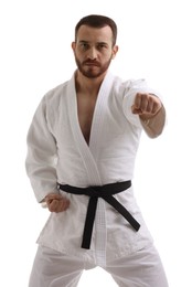 Man in uniform practicing karate on white background