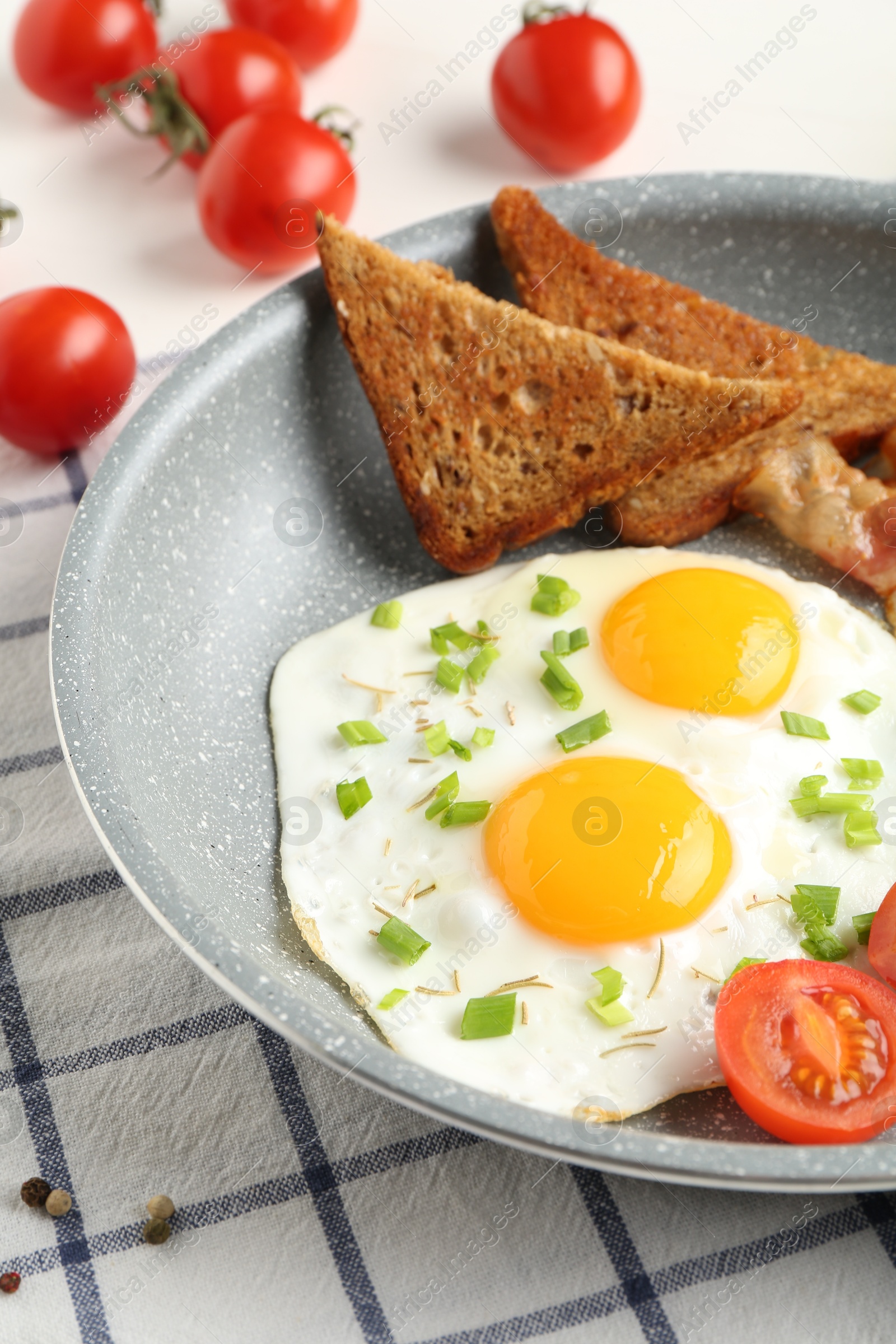 Photo of Tasty fried eggs with toasts served on table, closeup