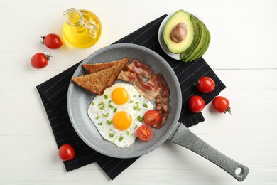 Photo of Tasty fried eggs with bacon and toasts served on white wooden table, flat lay