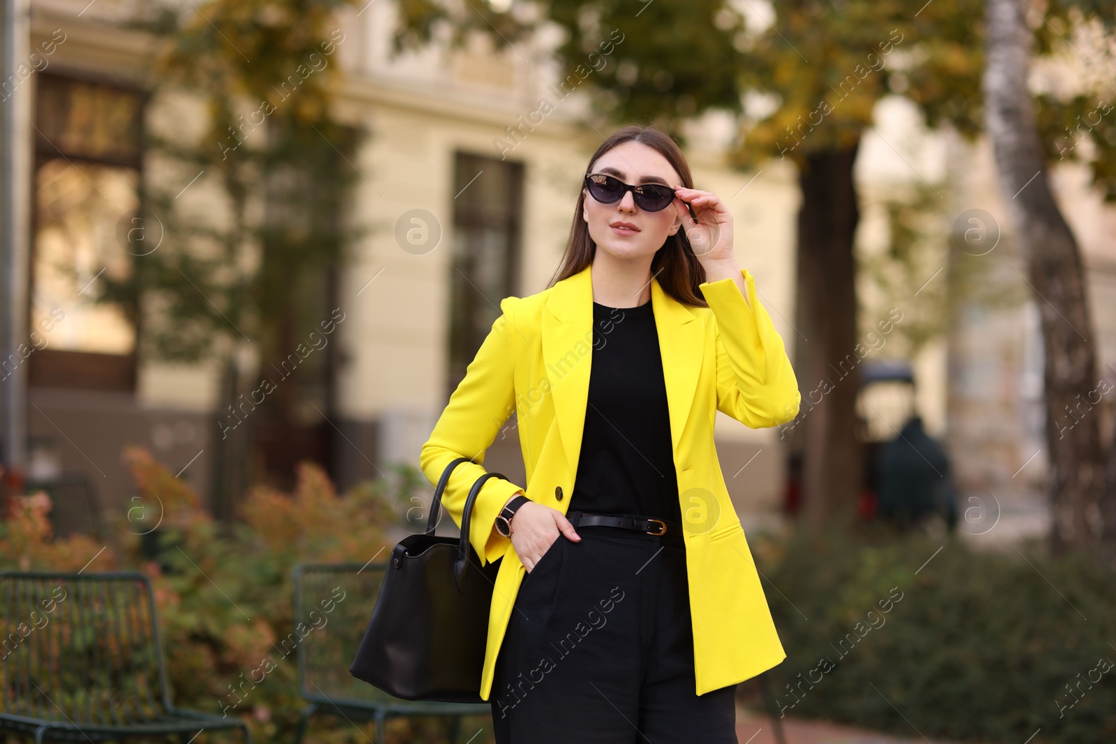 Photo of Businesswoman in stylish suit on city street