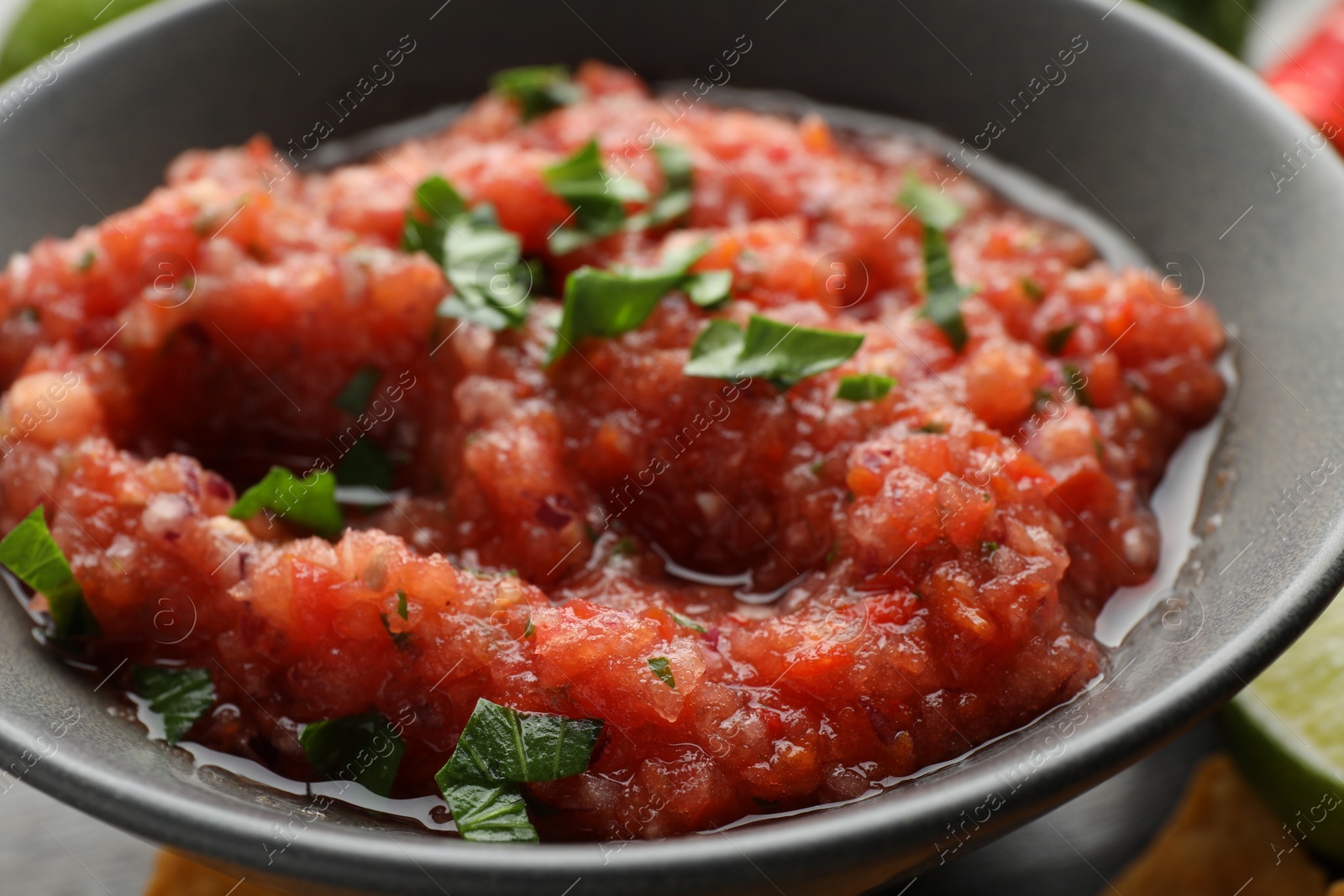 Photo of Delicious spicy salsa sauce in bowl on table, closeup