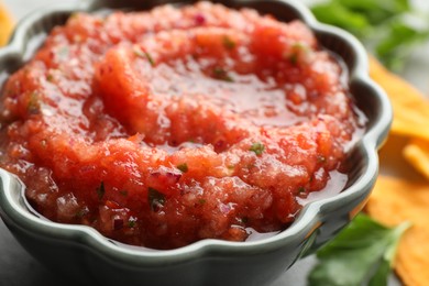 Photo of Delicious spicy salsa sauce in bowl on table, closeup