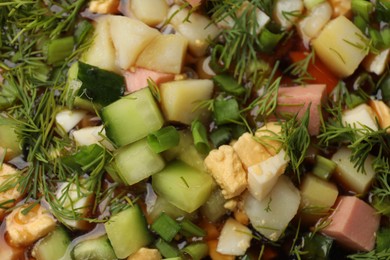 Photo of Tasty okroshka soup with kvass as background, closeup