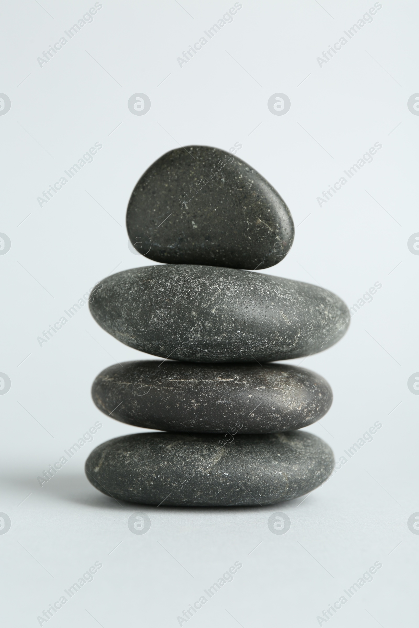 Photo of Stack of rocks on light background. Harmony and life balance