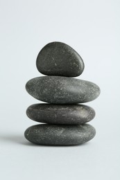 Photo of Stack of rocks on light background. Harmony and life balance