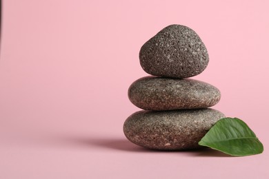 Photo of Stack of rocks on light pink background, space for text. Harmony and life balance