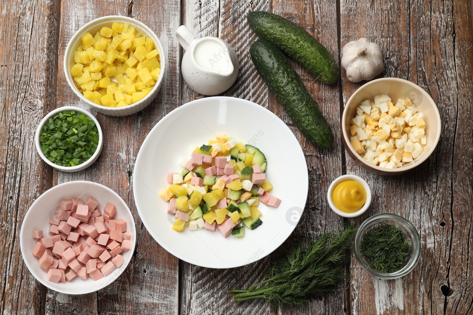 Photo of Ingredients for okroshka soup on wooden table, flat lay