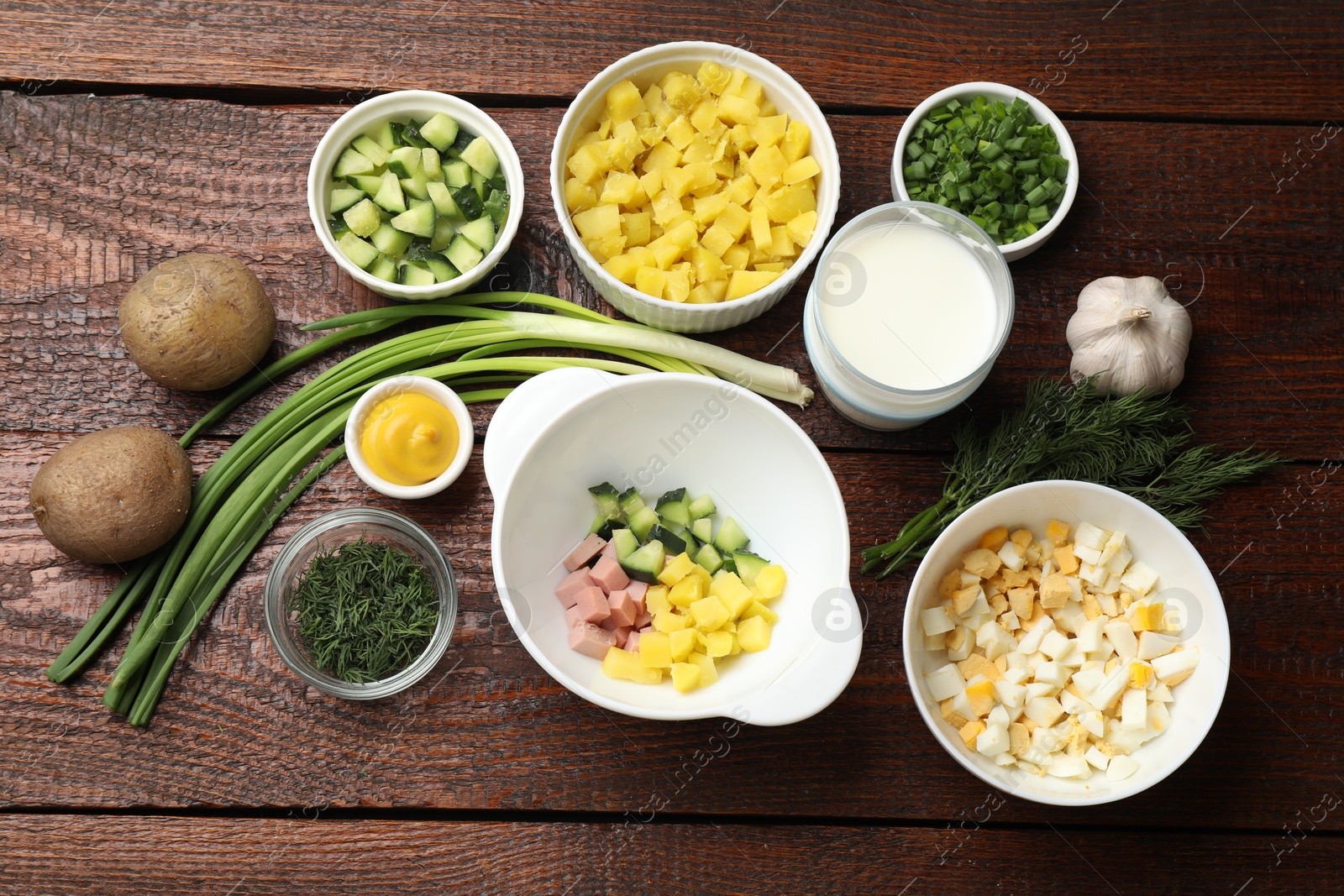 Photo of Ingredients for okroshka soup on wooden table, flat lay