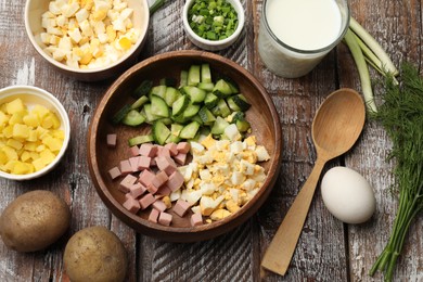 Photo of Different ingredients for okroshka soup on wooden table, flat lay