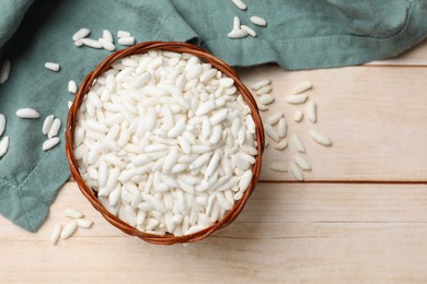 Photo of Puffed rice in bowl on wooden table, top view. Space for text