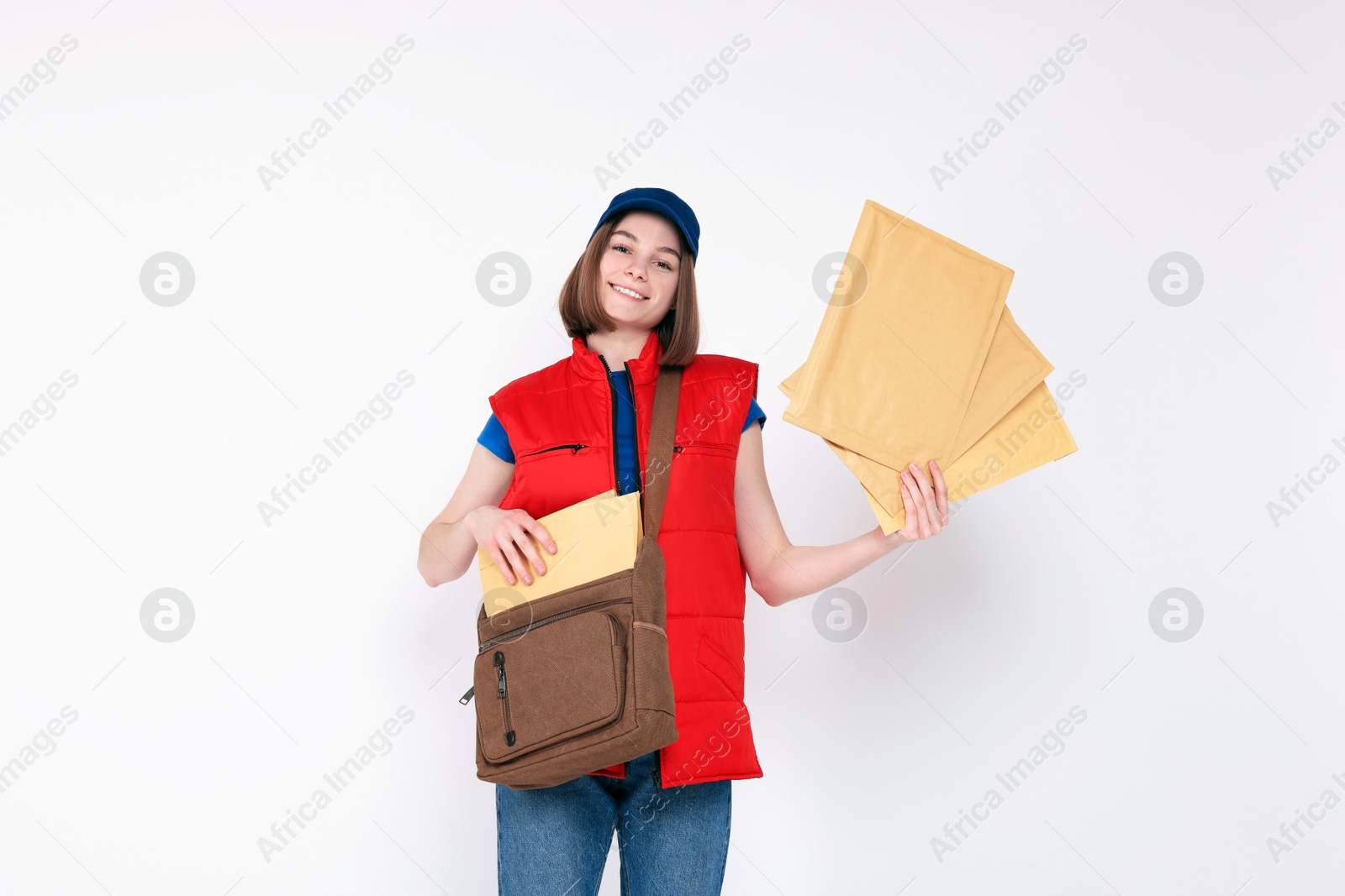 Photo of Happy postwoman with bag and envelopes on white background