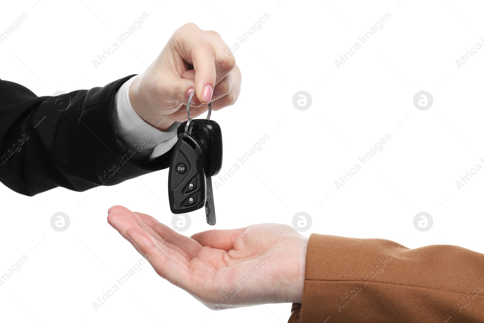 Photo of Dealer giving car keys to customer on white background, closeup. Buying auto