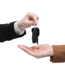 Photo of Dealer giving car keys to customer on white background, closeup. Buying auto