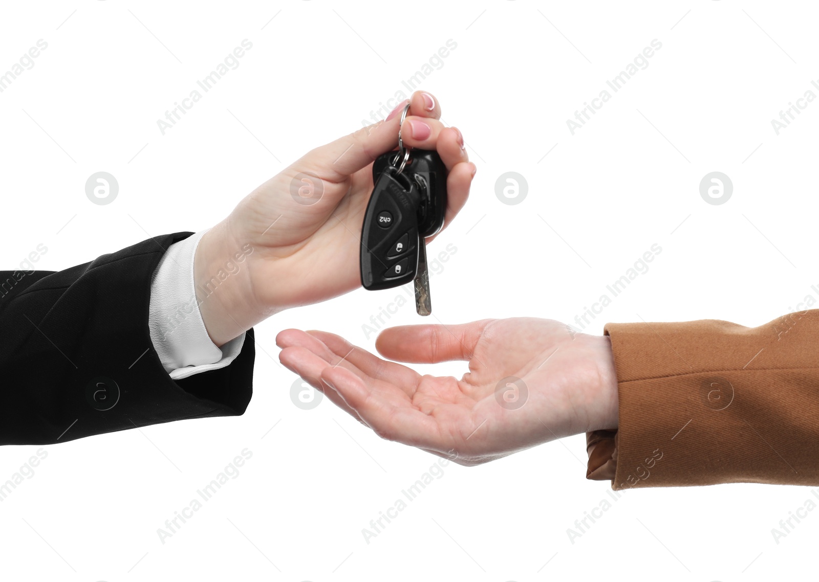 Photo of Dealer giving car keys to customer on white background, closeup. Buying auto