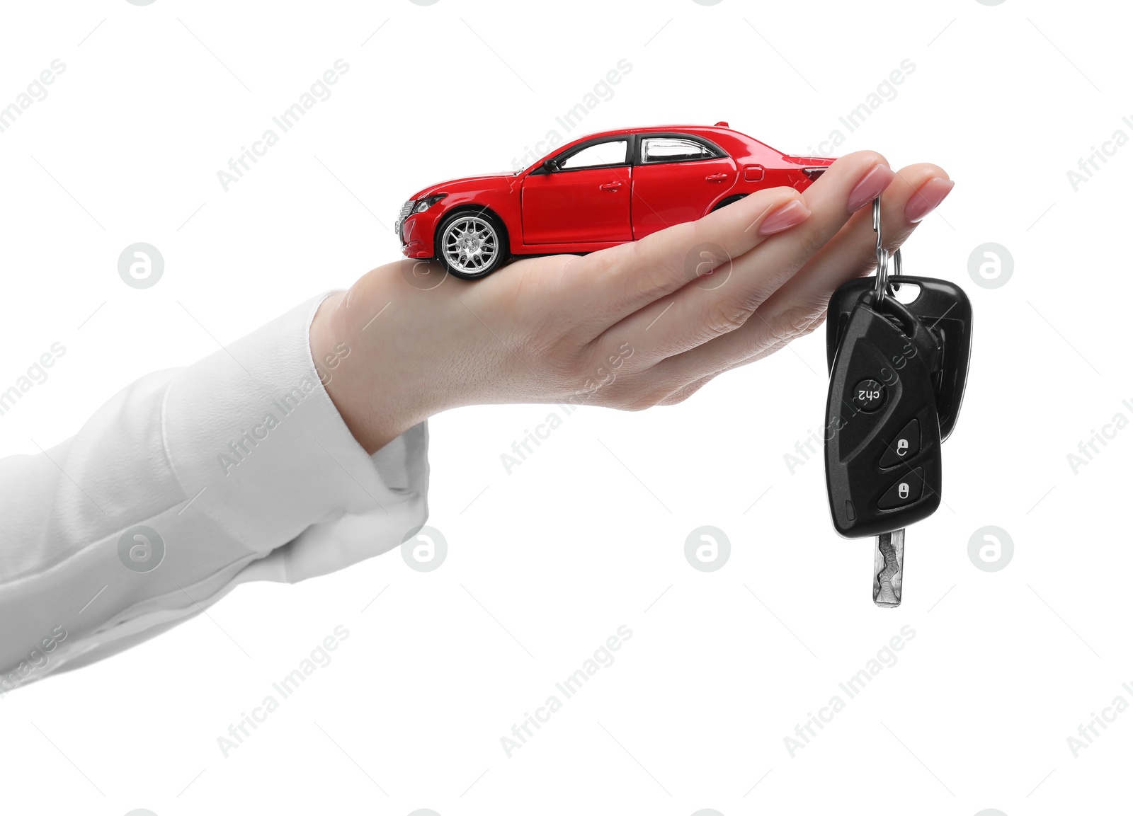 Photo of Woman with car model and keys on white background, closeup. Buying auto