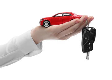 Photo of Woman with car model and keys on white background, closeup. Buying auto