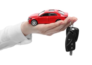 Photo of Woman with car model and keys on white background, closeup. Buying auto