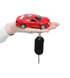 Photo of Woman with car model and key on white background, closeup. Buying auto