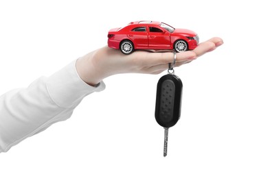 Photo of Woman with car model and key on white background, closeup. Buying auto