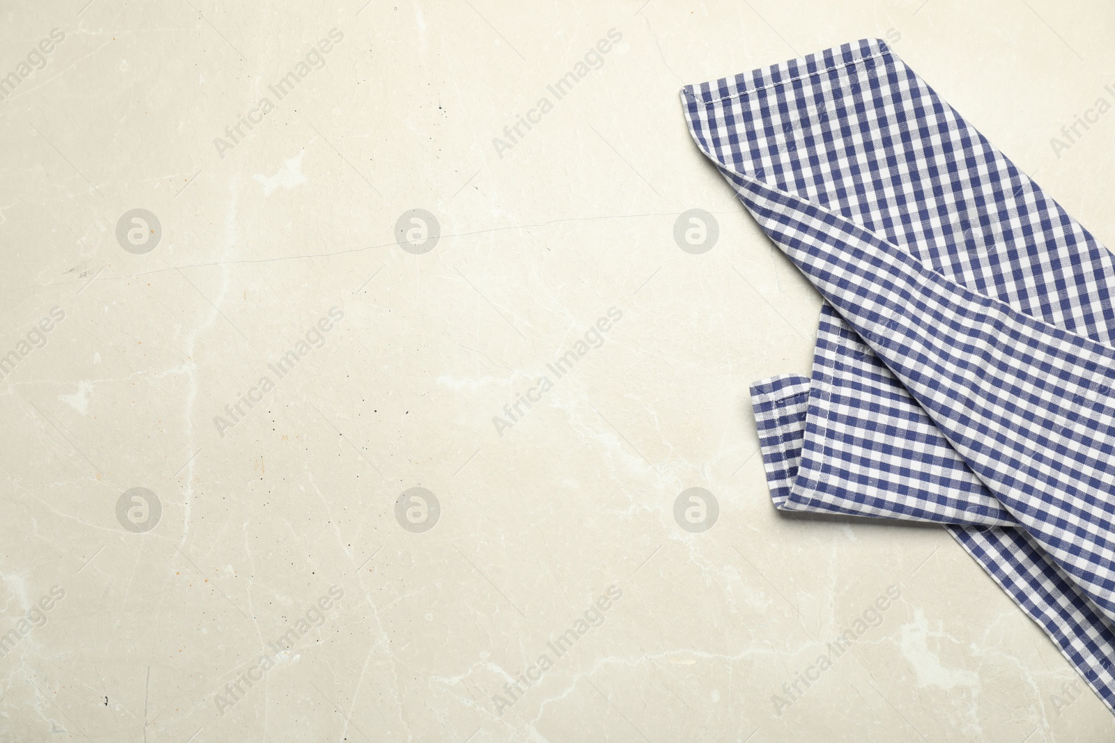 Photo of Blue checkered tablecloth on light gray textured background, top view. Space for text