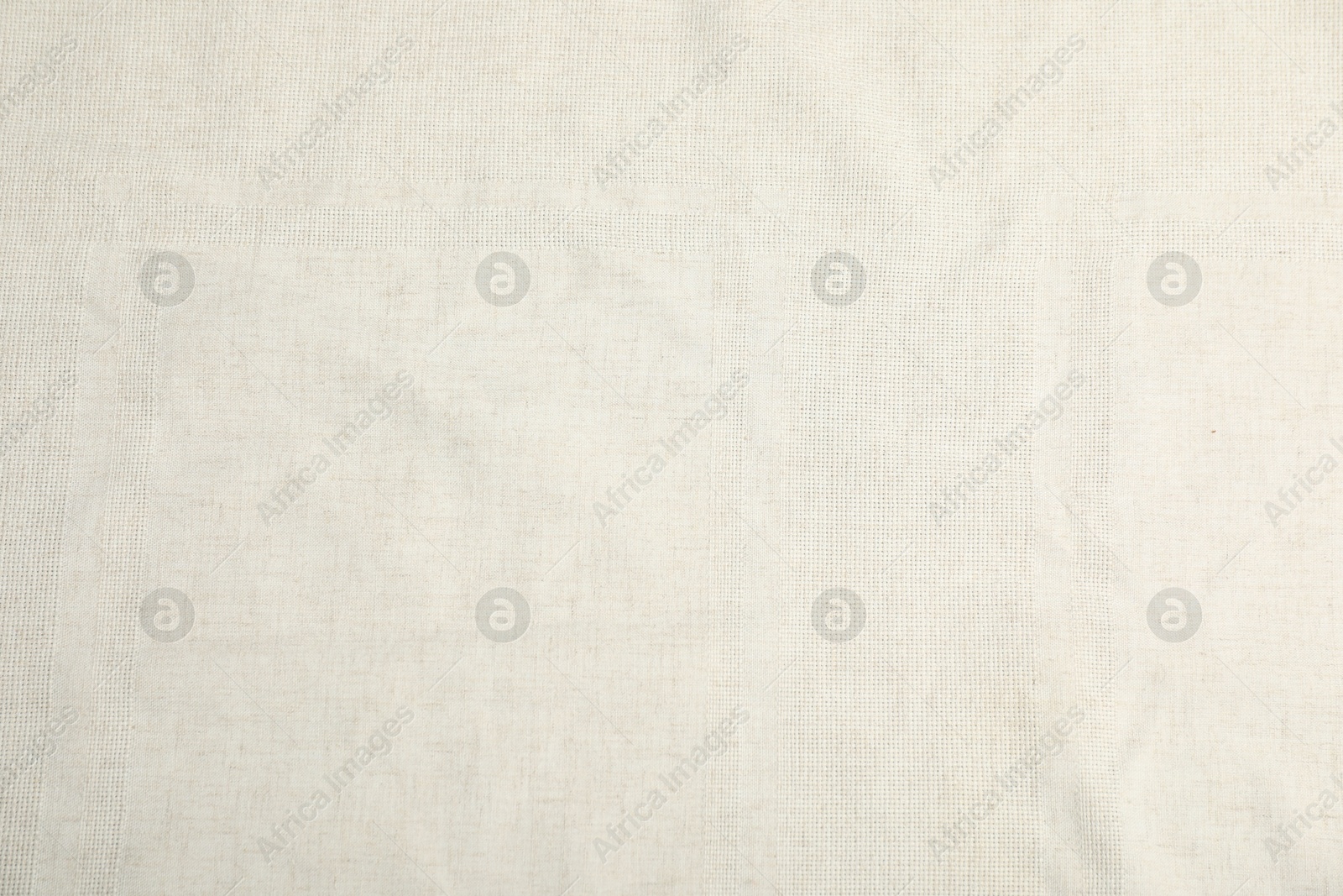 Photo of Texture of beige tablecloth as background, top view