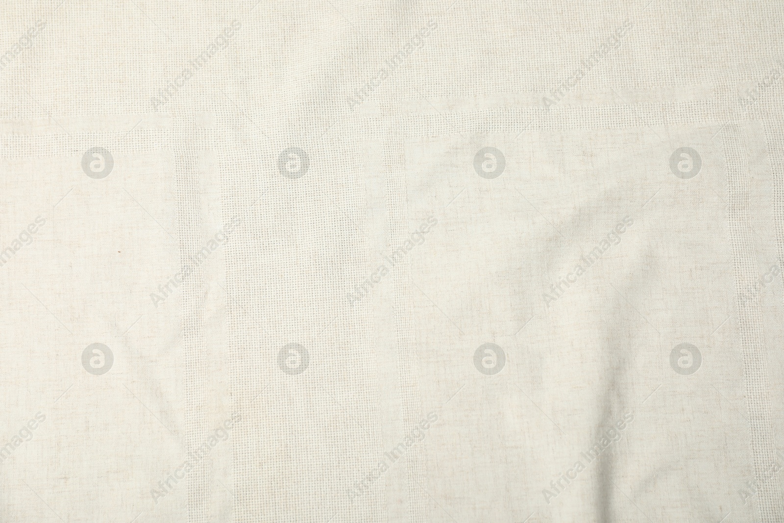 Photo of Texture of beige tablecloth as background, top view